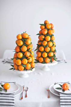 there are many oranges stacked on top of each other in the shape of trees