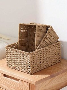 two wicker baskets sitting on top of a wooden table