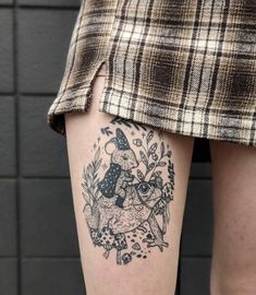 a woman's leg with a tattoo on it and an owl in the middle