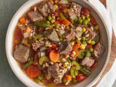 a white bowl filled with meat and vegetables