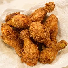 fried chicken on a paper towel in a basket