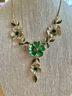 Flower jewelry was always big for Spring but this season's runways saw flowers blooming everywhere! This floral Y-necklace is an enamel and rhinestone beauty outlined in gold.  We want you to look beautiful, but keep your savings account, too: Our U.S. FREE SHIPPING guarantees your jewelry budget isn't eaten up by postage.  If you are interested in the coordinating earrings shown here you can purchase them by sending us a convo. Size: It's 16" with a 3" extender. Perfect for a wedding guest, or Dark Green Necklace, Taylor Tomasi Hill, Eva Chen, Flowers Blooming, Fashion Institute, Bib Necklaces, Necklace Statement, Green Flower, Flower Jewelry