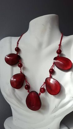 Tagua nuts make this African beaded necklace a versatile piece that works with most outfits. length: 8.5 inches when worn. *Ready to ship *Handmade *Eco friendly Please note that this is a handmade product, and the color pattern of the tagua nuts will differ for each necklace Your finished necklace is similar, but not exactly identical. Also, the color of the photo images may differ slightly due to variations in computer resolution. Images may also appear larger. Tagua nuts, also known as vegeta Gift Wooden Beaded Necklaces, Gift Wooden Beads Necklace, Unique Wooden Beaded Necklaces, Gift Beaded Necklaces With Wooden Beads, Casual Wooden Beaded Necklaces For Jewelry Making, Casual Wooden Beads Necklace For Jewelry Making, Red Fair Trade Necklace As Gift, Red Fair Trade Beaded Necklace As Gift, Fair Trade Unique Beaded Necklaces