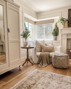 a living room filled with furniture and a fire place next to a mirror on the wall