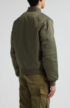 Classic detailing, such a sleeve utility pocket and ribbed trim, authenticates the military-inspired look of this bomber jacket crafted of nylon twill. 25 1/2" length (size Medium) Front zip closure Blade collar Ribbed cuffs and hem Front snap-flap pockets; sleeve utility pocket Lined 100% nylon Dry clean Imported Designer Clothing Military Style Nylon Khaki Outerwear, Military Style Solid Color Nylon Outerwear, Military Style Nylon Outerwear, Military Outerwear With Ribbed Cuffs For Outdoors, Military Style Nylon Outerwear With Multiple Pockets, Military Nylon Outerwear With Multiple Pockets, Khaki Nylon Outerwear With Side Pockets, Military Nylon Outerwear With Side Pockets, Olive Jacket