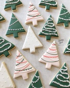 decorated christmas cookies arranged in rows on a table