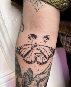 a woman's arm with a butterfly tattoo on it