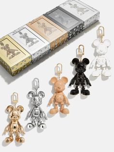 the mickey mouse keychains are all in different styles and colors, including gold