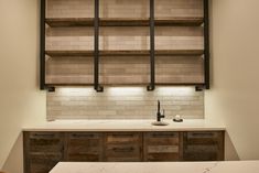 a kitchen with white counter tops and wooden cabinets