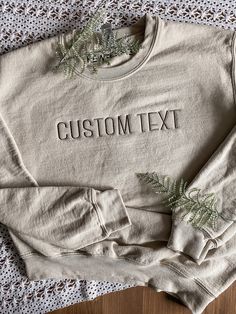 "CUSTOM TEXT EMBROIDERED APPAREL ♡ Gildan 18000 Heavy Blend Crewneck Sweatshirt T - Unisex ♡ Custom Text ♡ 100% Pre-Shrunk Cotton ♡ 40/50 Cotton/Polyester ♡ Made in the U.S. ♡ Model is wearing \"Sand\"; Size: S; Embroidery Thread: \"Brown\" IMPORTANT NOTICE: Crewnecks now have a paper like stabilizer that appears on the inside. This helps with increasing quality and ensure a longer lasting design on the sweatshirts. NOTE: Personalization will appear exactly as typed. Please ensure that all capit Basic Relaxed Fit Top With Custom Embroidery, Basic Cotton Tops With Custom Embroidery And Relaxed Fit, Basic Crew Neck Tops With Letter Embroidery, Cotton Crew Neck Tops With Custom Text, Cotton Crew Top With Custom Text, Brown Embroidery, Embroidered Apparel, Letter Sweatshirt, Embroidered Crewneck