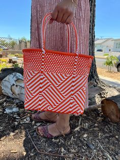 "This beautiful hand-woven, small tote is the latest creation of my business parter Cupertino. Handcrafted in Mexico. 9 1/2\"L x 9 1/2\"H x 5\"D; 16\" H with straps." Casual White Handwoven Shoulder Bag, Summer Handwoven Orange Shoulder Bag, Summer Orange Handwoven Shoulder Bag, Orange Shoulder Bag With Braided Handles For Shopping, White Handwoven Basket Shoulder Bag, Orange Handwoven Shoulder Bag For Shopping, White Handwoven Square Shoulder Bag, White Handwoven Rectangular Shoulder Bag, White Woven Basket Shoulder Bag