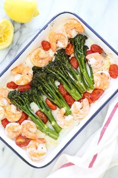 a casserole dish with shrimp, broccoli and tomatoes