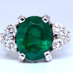 4.07ct Natural Oval Emerald Ring. 10 X 8mm Emerald, Even Green Clean Clarity And Transparent. Oil Enhanced .50 Carat Natural Round Diamond H-I Color Si-1 Si-2 Clarity 14 Karat White Gold 4.6 Grams Depth Of Ring 8 Mm Size 6 We May Resize Please Inquire $9000 Appraisal To Accompany Classic Oval Platinum Gemstones, Gia Certified Oval Gemstones For Fine Jewelry, Classic Oval Diamond Gemstones, Classic Oval Gemstone With Center Stone, Oval Emerald Ring With Prong Setting In Platinum, Oval Emerald Ring With Diamond Cut In Platinum, Oval Platinum Emerald Ring With Prong Setting, Oval Brilliant Cut Emerald Gemstones, Elegant Oval Solitaire Gemstone