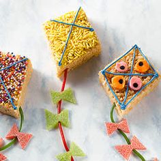 three pieces of cake with sprinkles and bows on them sitting next to each other