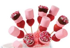 a vase filled with pink and red candy lollipops