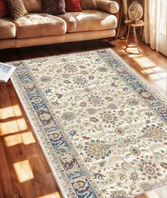 a living room with a couch and rug on the floor