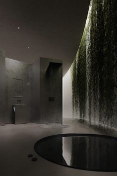 a modern bathroom with moss growing on the walls and flooring, along with a round black table