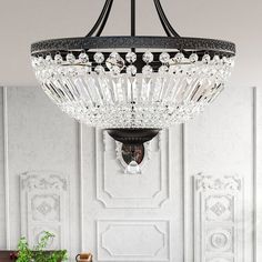 a chandelier hanging from the ceiling in a room with white walls and furniture