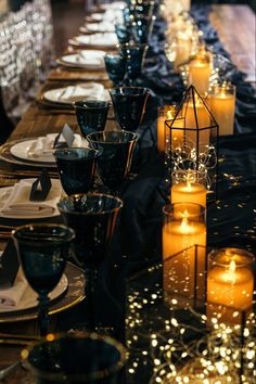 a long table with candles and plates on it