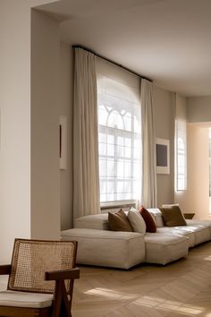 a living room filled with furniture and windows