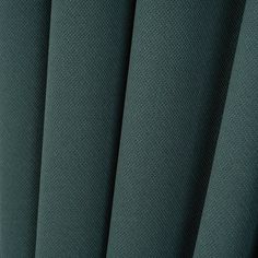 close up view of the pleaed fabric in dark green color, with small dots on it