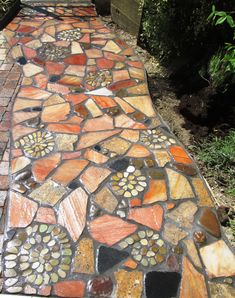 a walkway made out of various colored stones