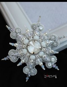 a snowflake made out of beads and pearls