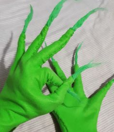 a green hand that is laying down on a bed