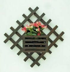 a wooden box with flowers in it on a wall