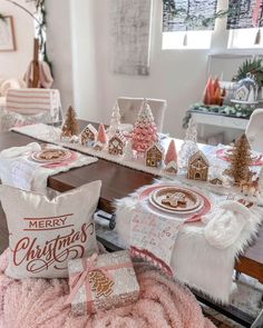 a dining room table decorated for christmas with gingerbread houses and other holiday decorations on it