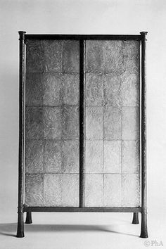 a black and white photo of a cabinet with two doors on one side and an open door on the other