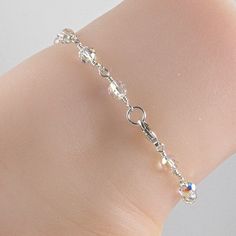 Add a touch of glamour to your outfit and accentuate the beauty of your legs with this gorgeous anklet. Made with clear Aurora Borealis Swarovski crystals, sterling silver wire and a sterling silver lobster clasp. This lovely ankle bracelet can be worn out dancing or with your favorite lingerie. Please choose the size that need from the drop down menu. The anklet should be approximately one inch larger than the ankle size. The anklet will arrive in an attractive gift box. Elegant Crystal Anklets With Adjustable Fit, Adjustable Crystal Anklets In Elegant Style, Elegant Crystal Anklets For Gifts, Elegant Crystal Bracelet With Lobster Clasp, Crystal Anklet, Beaded Anklet, Silver Anklet, Sterling Silver Anklet, Bracelet Crystal