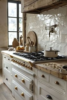 a kitchen with an oven, stove and counter top next to a window in the room