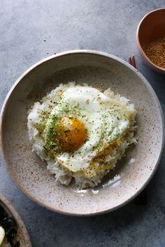 an egg is on top of rice in a bowl