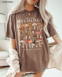 This Unisex garment-dyed t-shirt features "Study of Fungi | Mycology | Mushroom Collection" with a lovely set of watercolor mushroom illustrations. It is the perfect gift for present / future mycologists, science teachers, mushroom foragers & more! Make sure to check out the other garment options below :) » O P T I O N S « ‣ Crewneck: https://www.etsy.com/listing/1700683435 » A B O U T « ‣ This item is made to order using direct-to-garment (DTG) printing technology. This digital process involves Clothes Mushroom, Mushroom Illustrations, Girl Camping, Watercolor Mushroom, Mushroom Cottagecore, Camping Clothes, Science Gifts, Camping Outfits, Granola Girl