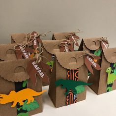 small brown paper bags with dinosaur tags on them