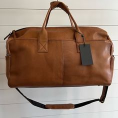 Shop artofalpine's closet or find the perfect look from millions of stylists. Fast shipping and buyer protection. Danish leather men’s travel bag. Structured leather color cognac with crossbody strap and side exterior pockets Rolling Briefcase, Travelon Bags, Bike Saddle Bags, Tumi Luggage, Large Duffle Bag, Golf Stand Bags, Weekend Travel Bags, Leather Travel Bag, Duffel Bag Travel