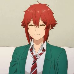 an anime character with red hair wearing a suit and tie, sitting on a couch