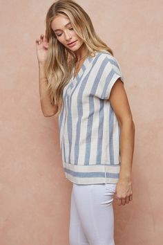 Let your shoulders relax in this breezy top. The short sleeve v-neck stripe design features an off-white and dusty blue color palette that allows you to feel the cool air and take that much needed breath of freshness. Slip this top on for an effortlessly chic look that will have you feeling comfortably at ease. 100% Cotton TOTAL LENGTH 28 1/2″| BUST 24″| SHOULDER 27″ Want to view this on the *Live* Sizing & Styling Guide?! Watch it in the photo section above! *You will need to scan through to fi Chic Blue V-neck Top For Summer, Relaxed Fit Short Sleeve V-neck Top For Summer, Striped V-neck Blouse For Vacation, Striped V-neck Blouse For Summer, Breezy V-neck Summer Top, Summer Striped Short Sleeve Tops, Striped Short Sleeve Summer Top, Striped V-neck Summer Tops, Relaxed Striped Tops For Spring