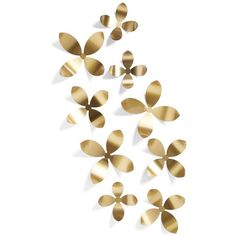 gold metal flowers are arranged in the shape of petals on a white background with shadows