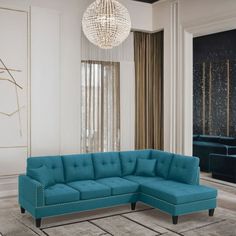 a living room with a blue sectional couch and chandelier hanging from the ceiling