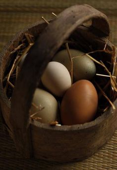 a basket filled with brown and white eggs