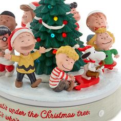 a group of figurines that are next to a christmas tree