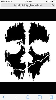 a black and white image of a skull with paint splattered on it's face