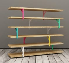 a wooden shelf with different colored shelves on it