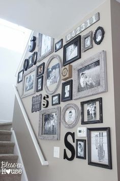 a staircase with many pictures on the wall