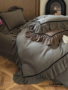 a bed with ruffled bedspread and pillows