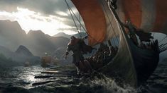 a group of people riding on top of a boat in the ocean next to mountains