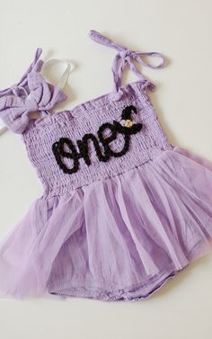 Beautiful one romper for your little Halloween babe. This listing is for a purple romper, one lettering in black and a witch hat appliqué next to it.  Halloween Birthday Spooky Birthday  Birthday photoshoots, special events, etc. If you'd like a different color or saying, don't hesitate to contact us Spooky One First Birthday Girl Outfit, Spooky Birthday, Birthday Romper, Witch Hat Halloween, Purple Romper