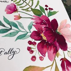 a close up of a greeting card with flowers and leaves on the inside of it